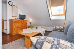 a living room with a couch and a table at Ferienpark Freesenbruch Wohnung 4 5 - Kranichtanz in Zingst