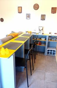 a kitchen with tables and chairs in a kitchen at le Refuge d'Eugénie in Bahus-Soubiran