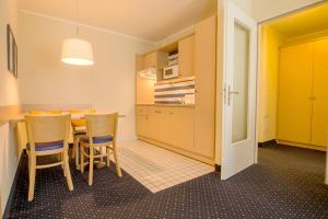 a kitchen and dining room with a table and chairs at Haus Seeblick Wohnung 326 in Zingst