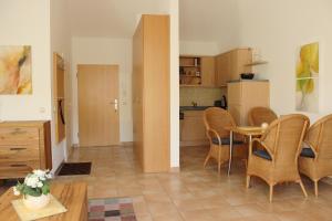a kitchen and a dining room with a table and chairs at Residenz am Strand Wohnung 2-40 in Zingst
