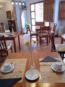 a dining room table with a vase on top of it at Hotel La Llosona in Ribadesella