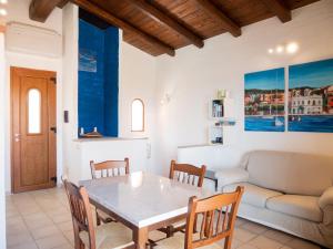 a living room with a table and a couch at La Casa Del Mare Tanca Piras in Nebida