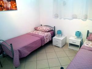 A bed or beds in a room at Appartamento La Bonifica