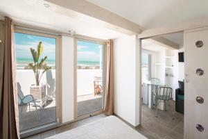 a room with a balcony with a view of the ocean at Villaggio Camping Oasi in Vieste