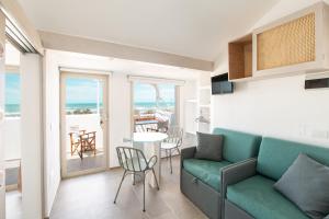 a living room with a couch and a table at Villaggio Camping Oasi in Vieste