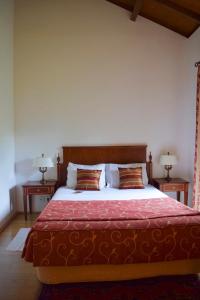 a bedroom with a large bed with two tables at Mosteiro De S. Cristovao De Lafoes in São Cristóvão de Lafões