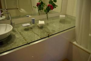 a bathroom counter with a sink and a mirror at Mosteiro De S. Cristovao De Lafoes in São Cristóvão de Lafões