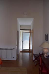 an empty living room with a door leading to a patio at Mosteiro De S. Cristovao De Lafoes in São Cristóvão de Lafões