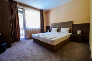 a bedroom with a bed and a large window at Relax Houses in Ognyanovo +27 photos