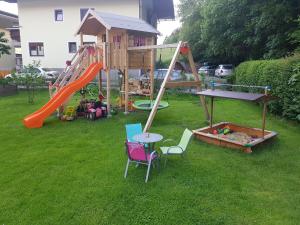 a playground with a slide and a table and chairs at Apart Dahuam in Aschau