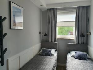 Ένα ή περισσότερα κρεβάτια σε δωμάτιο στο Apartament Nord 13 Willa Nord