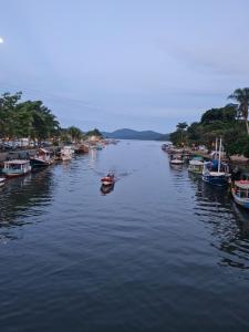 a group of boats are docked in a river at Pousada Manga Rosa in Paraty