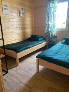 a room with two beds and a window at Rodzinne Rusinowo II in Rusinowo