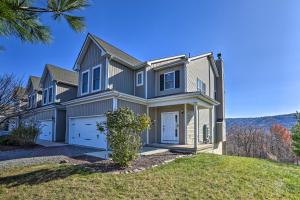 a house with a garage on a hill at New ! Slopeside Townhome : WFH, Ski, Dine & Hike in Tannersville