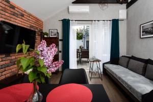 a living room with a couch and a table at Apartamenty Prestige in Łeba