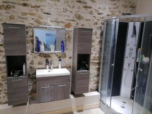 a bathroom with a shower and a sink and a shower at B&B Colvestre in Tréguier