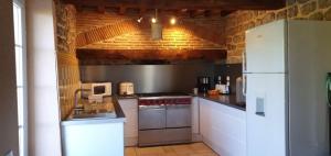 a kitchen with white appliances and a white refrigerator at Gite Le Morvan in Lormes