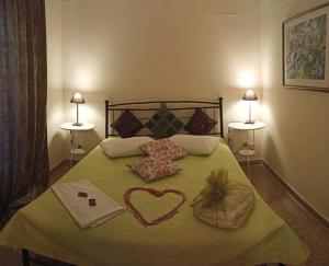 a bedroom with a bed with a heart on it at Anatoli Hotel in Agia Marina Aegina