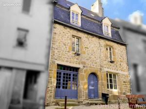 an old stone building with blue doors and windows at B&B Colvestre in Tréguier