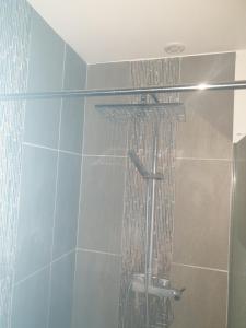a shower with water coming out of it at Chambre privée au coeur de Calais in Calais