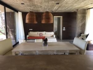 a living room with a table and a couch at CASA HORTENSIAS in Quequén +20 photos