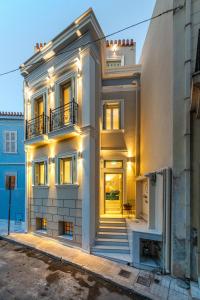 a white house with lights on it at IPELHOME - Plaka Boutique Apartments in Athens