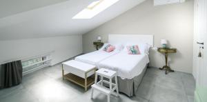 a bedroom with a white bed with two pillows at Dei Molini in Foligno