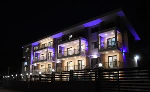 a building with blue lights on it at night at Theano Luxury Suites Nikiti in Nikiti