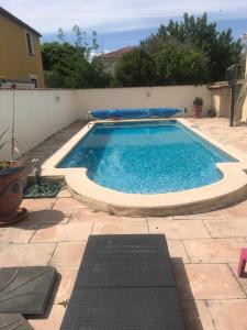 a large swimming pool in a backyard with at Villa Mamamia T4 avec piscine proche commerce au pied des Cévennes in Laroque