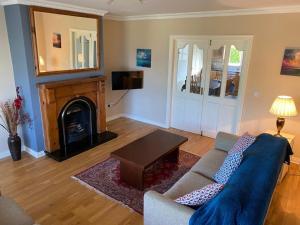 a living room with a couch and a fireplace at Holiday Home Waterville in Waterville