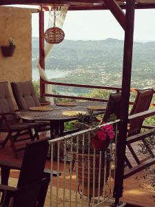 a table and chairs on a balcony with a view at Lorantina House_ Holidays in Corfu in Spartýlas