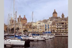 a group of boats are docked in a harbor at Vittoriosa holiday apartment rental with Ac in Vittoriosa