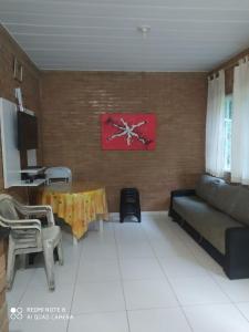 a living room with a couch and a table at Recanto beira rio in Sana +15 photos