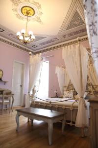 a bedroom with a bed and a chandelier at Nostos Hotel in Galaxidhion