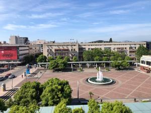 a city square with a fountain and buildings at Square apartment Podgorica in Podgorica
