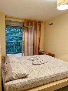 - une chambre avec un lit et une grande fenêtre dans l'établissement Arti apartment, à Vlorë