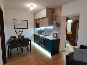a kitchen and dining room with a table in a room at Apartmán Pri Lese in Veľký Slavkov