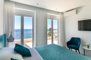 a bedroom with a bed and a view of the ocean at Villa Leoni in Dubrovnik
