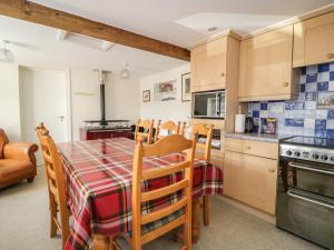 a kitchen and dining room with a table and chairs at Coombs View in Low Hesket