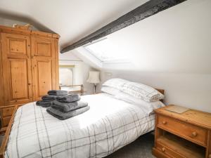 a bedroom with a bed with towels on it at Coombs View in Low Hesket