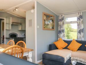 a living room with a blue couch and a table at Valley Lodge in Tiverton