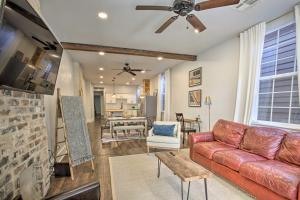 a living room with a couch and a dining room at Chic Escape with Furnished Deck Walk to Cafes! in New Orleans