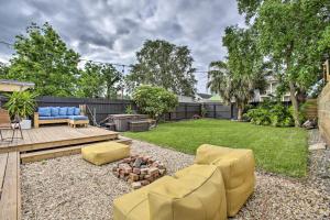 a backyard with a couch and a fire place at Chic Escape with Furnished Deck Walk to Cafes! in New Orleans