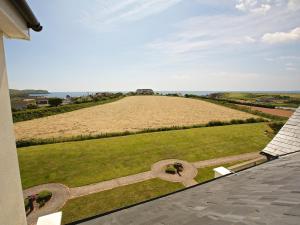 a view of a field from the roof of a house at Ocean View Apartment in Thurlestone