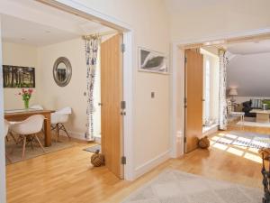 a living room with a door open to a dining room at Ocean View Apartment in Thurlestone