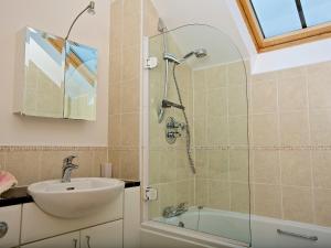 a bathroom with a sink and a shower at Ocean View Apartment in Thurlestone