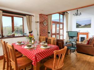 a dining room with a table and chairs at The Granary Malborough in Malborough