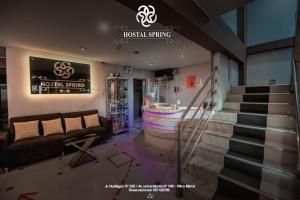 a lobby with a couch and stairs in a store at Hostal Spring in Huánuco