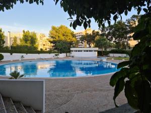 a large swimming pool with blue water at 3 Castelos Sunset - Praia da Rocha in Portimão