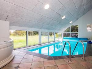 a swimming pool in a house with a toilet at 12 person holiday home in Glesborg in Fjellerup Strand